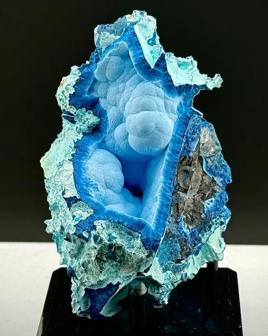 This surreal shattuckite specimen features a striking open cavern lined with…